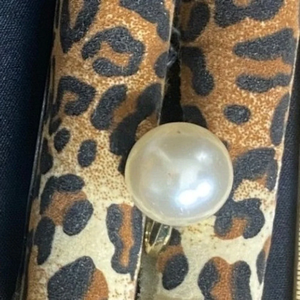 A‎ gold-tone adjustable fashion ring with a large faux pearl dome. Unbranded